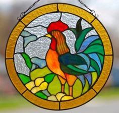 a stained glass window with a rooster on it