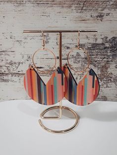 Add a touch of contemporary sophistication to your jewelry collection with these stunning geometric earrings. Expertly handcrafted with attention to detail, these earrings are designed to elevate your style and make a bold statement.  Materials:  - Zinc alloy  - Wood  Dimensions: - 8CM x 4.7CM  Why Choose Our Geometric Earrings?  - Lightweight and comfortable for all-day wear  - Perfect as a gift for birthdays, anniversaries, or any special occasion - Handmade with love in our studio, guaranteei Retro Multicolor Metal Earrings, Modern Multicolor Dangle Earrings, Modern Circular Earrings For Party, Handmade Modern Geometric Earrings, Modern Handmade Geometric Earrings, Modern Geometric Metal Hoop Earrings, Modern Geometric Hoop Earrings With Ear Wire, Chic Geometric Earrings For Party, Modern Geometric Ear Wire Earrings