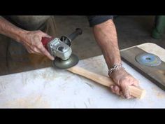 a man using a sander on a piece of wood