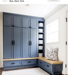 a kitchen with blue cabinets and white dishes