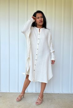 Relax in style with the Aura shirtdress, a unique take on traditional loungewear. Made from breathable double gauze cotton, it's perfect for casual wear out, at home, or even as a beach coverup. The button-down design adds a touch of style and versatility to your wardrobe, ensuring comfort and convenience as you go about your day. Oversized Cotton Linen Dress For Vacation, Oversized Cotton Linen Vacation Dress, Oversized Button-up Shirt Dress For Beach, Chic Cotton Shirt Dress For Beach, Chic Cotton Shirt Dress For The Beach, Oversized Button-up Shirt Dress For Vacation, Long Sleeve Cotton Shirt Dress For Beach, Long Cotton Shirt Dress For Vacation, White Bohemian Shirt Dress For Summer