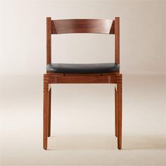 a wooden chair with a black leather seat pad and back rest on a white background