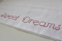 a close up of a piece of cloth with the words sweet dreams embroidered on it