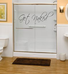 a bathroom with a walk in shower next to a toilet