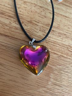 "These gorgeous glass heart pendants are absolutely stunning. The pendants are about the size of a quarter. It is strung beautifully along a black cord with adjustable rings to be between 20-22\" in length and is finished with a lobster clasp.  This can be placed on 18-20\" length if requested. This is an absolutely gorgeous pendant and would be a great birthday present, anniversary present, Mother's Day gift, Valentine's Day  present, or graduation gift. The sleek design of this pendant will turn heads and make you take a second look! Like what you see? View more at: https://www.etsy.com/shop/StephsCraftingBits" Valentine's Day Glass Necklaces Gift, Heart-shaped Glass Necklace For Valentine's Day, Heart-shaped Glass Jewelry For Valentine's Day, Clear Heart Pendant Jewelry For Valentine's Day, Glass Heart Pendant Necklace For Gift, Valentine's Day Heart-shaped Glass Necklace, Iridescent Heart Pendant Jewelry For Valentine's Day, Glass Heart Pendant Jewelry For Gift, Glass Heart Pendant Jewelry Gift