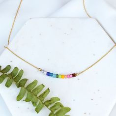 I call these little beaded necklaces "Color Flights" - almost like a mood ring for your neck! Feeling like a rainbow today? Perfect! Here is the necklace for you. A hand selected grouping of glass beads in rainbow colors are carefully strung on a dainty gold filled cable chain. Beaded area measures a little over 1" across. Necklace Details all metals are gold filled (nickel free) adjustable with 16" to 18" length handmade in Nashville, TN Rainbow Necklaces With Spacer Beads For Jewelry Making, Rainbow Spacer Beads Jewelry As A Gift, Rainbow Crystal Necklaces With Colorful Beads For Gift, Adjustable Rainbow Necklaces With Spacer Beads, Rainbow Jewelry With Beaded Round Beads, Rainbow Beaded Chain Jewelry With Round Beads, Rainbow Round Beads Dainty Jewelry, Rainbow Jewelry With Round Beaded Chain, Rainbow Dainty Jewelry With Round Beads