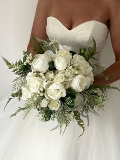 a bridal holding a bouquet of white flowers