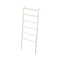 a white ladder with two shelves on each side and one shelf above the top, in front of a white background