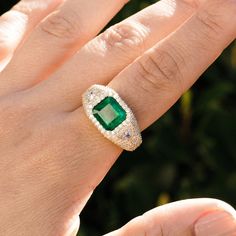 Beautifully crafted from 14K yellow gold, this stunning bombe ring features an emerald-cut emerald centerpiece surrounded by shimmering pave diamonds with trillion cut white diamonds on each side. An exquisite choice for special occasions, this classic glamour piece is sure to make a statement. 14K yellow gold Emerald (Emerald cut); Diamonds, approximately 2.98 carats Dimensions: 14mm x 12mm Size 8 One of a kind Designed in California Style number: SRG086-8 Luxury Trillion Cut Diamond Emerald Ring, Luxury Trillion Cut Emerald Diamond Ring, Luxury Trillion-cut Emerald Ring, Emerald Cut Diamond Ring With Pave Setting, Luxury Emerald Cut Cubic Zirconia Emerald Ring, Bombe Ring, Classic Glamour, Stacked Necklaces, California Style