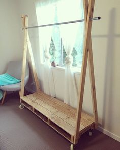 a wooden swing sitting in front of a window