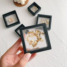 a person holding up some jewelry in their hand