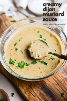 a spoon in a bowl filled with creamy mustard sauce