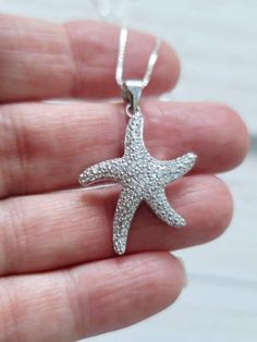 Sparkling CZ Starfish Pendant with chain in Genuine Sterling Silver A perfect gift for the beach lover! Starfish measures 1 1/4 inch long and 23mm wide 925 Sterling Silver Cable or Box Chain (you select at checkout) Arrives in a Beautiful necklace gift box Starfish Necklace, Starfish Crystal CZ Drop Pendant, Silver Starfish Necklace, Beach Jewelry, StarFish Charm, Vacation Jewelry, sterling silver, 925, gift, Mother, Sister, Daughter, girlfriend, wife, friend Beach Wedding Jewelry, Vacation Jewelry, Necklace Gift Box, Starfish Pendant, Starfish Necklace, Wedding Party Jewelry, Pendant With Chain, Beach Lover, Bridesmaid Necklace