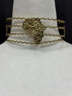 Expertly handcrafted and adjustable, our African map choker is a unique and stylish addition to any outfit. Show off your love for Africa with this one-of-a-kind piece, perfect for casual or formal occasions. Unique Metal Choker With Adjustable Chain, Unique Adjustable Chain Choker, Unique Brass Choker For Festivals, Unique Adjustable Metal Choker, Unique Adjustable Choker For Parties, Gold Resizable Choker As Gift, Resizable Gold Choker As Gift, Adjustable Brass Choker With Chain, Adjustable Brass Chain Choker