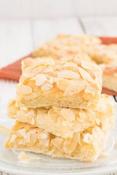 three pieces of cake sitting on top of a glass plate with the words saffiger butterkuchen