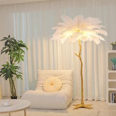 a living room filled with furniture and a large white palm tree in the middle of it