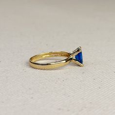 Discover elegance and timelessness with our 18k Gold Filled Royal Blue Solitaire Ring. Crafted with precision and detail, this ring exudes a regal allure that will elevate any outfit. A must-have for those who appreciate luxury and sophistication. Metal: 18k Gold filled Available sizes: 5.5, 6,7, 8, and 9 Hypoallergenic Water-resistant Handcrafted in Brazil Luxury Trillion Cut Sapphire Ring For Formal Events, Luxury Trillion Cut Sapphire Ring For Formal Occasions, Formal Tanzanite Trillion Cut Ring, Classic Formal Sapphire Ring With Trillion Cut, Classic Trillion Cut Sapphire Ring, Elegant Royal Blue Brilliant Cut Rings, Luxury Tanzanite Promise Ring, Elegant Gold Rings With Tanzanite, Elegant Gold Tanzanite Rings