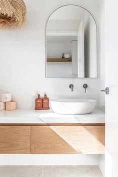 a bathroom with a sink, mirror and soap dispenser on the counter