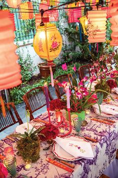 the table is set with many plates and place settings