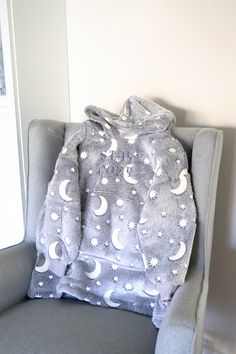 Oversized wearable blanket with hood, super warm and cozy. Can be personalised with a short text or name. Items with personalisation cannot be retuned. Thread colours can be changed for free to match the blanket colour.  Any personalised options can be discussed, do not hesitate to drop a message. In the picture is a glow in the dark grey hoodie size 3-7 yo. Superior high-pile fleece fabric gives a better quality, thicker and more luxurious finish. Super soft sherpa lining.Self colour elasticated cuffs. Domestic wash 40oC. Cozy Hooded Hoodie For Sleepover, Blanket With Hood, Dark Grey Hoodie, Short Text, Blanket Sweater, Blanket Hoodie, Christmas Hoodie, Hoodie Blanket, Wearable Blanket