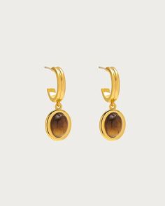 Sass up your lobes with an instinctive gaze. These gold hoop earrings, adorned with Tiger’s Eye natural stone, boast a crystal depth that dances with shades of gold and brown. The Tiger's Eye, revered for its grounding energy, reflects a bold, unwavering spirit of chasing love. Wear these treasures and step into a love En Route Jewelry, Eye Natural, Grounding Energy, Heart Hair, Soft Autumn, Shades Of Gold, Instagram Tags, Tiger Eye Stone, Eye Stone