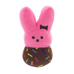 a pink stuffed animal with sprinkles on it's face and ears