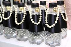 there are many bottles with pearls on them