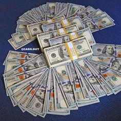 a pile of money sitting on top of a blue table