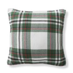 a green and white plaid pillow on a white background