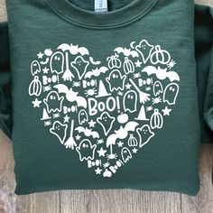 a green t - shirt with the word boo written in it's heart shape