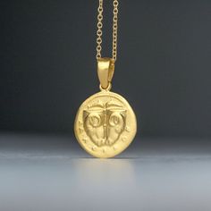 Solid gold ancient Greek coin necklace, inspired by the 5th century BC Delphi coin (Phokis). There is an image on both sides and can be worn either way. It pictures two rhyta (drinking vessels) in the form of ram's heads, above, two dolphins are swimming toward each other; ΔAΛΦ-I-KON in small letters below on the other side, the backside, it pictures a Quadripartite incuse square in the form of a coffered ceiling; each coffer decorated with a dolphin and laurel spray. This is a replica of an anc 14k Gold Amulet Coin Necklace Tarnish Resistant, 14k Gold Round Pendant Amulet Coin Necklace, Symbolic Yellow Gold Coin Medallion Necklace, Symbolic Yellow Gold Coin Pendant Necklace, Ancient Yellow Gold Coin Pendant Jewelry, Yellow Gold Amulet Coin Necklace, Yellow Gold Coin Pendant Necklace In Amulet Style, Ancient Yellow Gold Medallion Necklace, Ancient Style Medallion Necklace In Yellow Gold