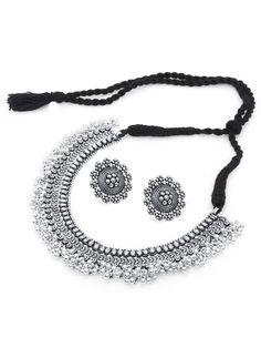 This jewellery set consists of a necklace, a pair of earrings, a finger ring and a nose pin Oxidised silver-plated choker necklace, has intricate textured detailing and bead droplets, secured with a drawstring closure A pair of matching stud earrings, secured with post-and-back closure Oxidised silver-plated adjustable finger ring, has a floral-shaped design motif Oxidised silver-plated nose pin with clip-on closure Size & Fit Necklace length: 42 cm Necklace width: 3 cm Earring length: 2.8 cm each Nose pin length: 1.7 cm Ring dimension: Adjustable Material & Care Material: German silver Plating: Oxidized silver-plated Care Instructions: Wipe your jewellery with a soft cloth after every use Always store your jewellery in a flat box to avoid accidental scratches Keep sprays and perfumes away Oxidized Necklace, Jewelry Cleaning Solution, Chandbali Earrings, Nose Pin, Pakistani Jewelry, Indian Earrings, Oxidised Jewellery, Jewelry Choker, Jewellery Set