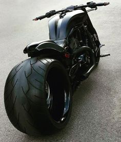 the motorcycle is parked on the side of the road with it's front tire