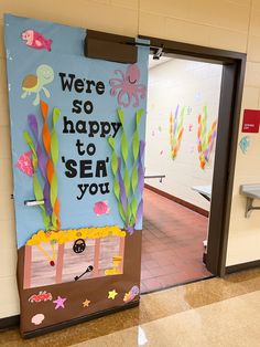 a door decorated with sea life and the words we're so happy to sea you