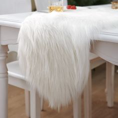 PRICES MAY VARY. Polyester Size: The white fur table runner measures about 30x150 cm, Perfect for decorating your Christmas dining table, dresser, bench ,fireplace ,bed runner decor. Material: White Christmas table runner is made of fluffy faux fur: 100% polyester ,acrylic:20% , Bottom : 100% polyester (Note: The Runner is a vacuum compression package, you will see wrinkles when you open it for the first time, Please leave it for a few days and comb the fur smoothly ) Applications: Winter table Dresser Fireplace, Bench Fireplace, Fur Table, Silver Tablecloth, Snowflake Centerpieces, Winter Table Decor, Fireplace Decorations, Dresser Bench, Sparkling Candle