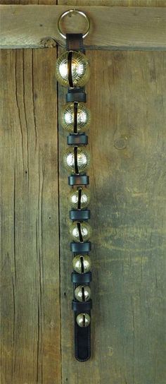 a keychain hanging from the side of a wooden door with lights on it