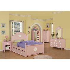 a child's bedroom with pink furniture and yellow walls