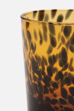 an animal print glass is shown against a white background