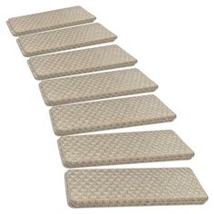 five beige mats are lined up in a row