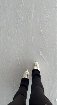 someone is standing on the ice with their feet up