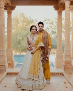 The bride's haldi outfit is usually a radiant yellow or golden attire, symbolizing auspiciousness and happiness. The outfit is often accessorized with delicate jewelry, such as earrings, On the other hand, the groom's haldi outfit typically consists of a vibrant yellow kurta paired with comfortable bottoms, like pajamas or churidars Haldi Outfit, White Lehenga, Wedding Jumpsuit, Red Lehenga, Bollywood Wedding, Haldi Ceremony, Kiara Advani