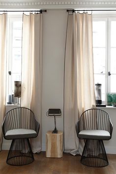 two chairs sitting next to each other on top of a hard wood floored floor