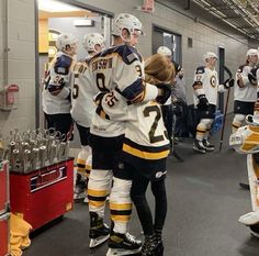 the hockey players are congratulating each other in the locker room at the game