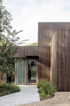 a house with wooden siding and glass doors