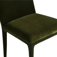 a green velvet chair with black legs