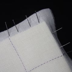 a close up view of some pins on a piece of fabric