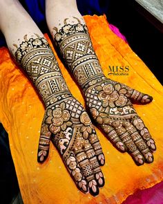 two hands with henna designs on them