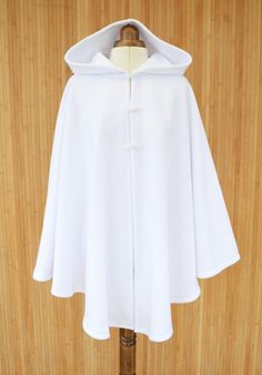 Envelop yourself in this pure white hooded cape, made from super soft fleece fabric and finished with three toggle buttons.  Standard size: fits 8 to 16 UK sizes/ 4 to 12 US sizes. Length 78cm / 31 inch Plus size: fits 18 to 24 UK sizes/ 14 to 20 US sizes. Length 86cm / 34 inch * If your height is White Cape With Hood, Bridal Cloak, Wedding Dress Cover Up, Cape Tutorial, White Cloak, White Poncho, White Cape, Cape Cloak, Cashmere Cape