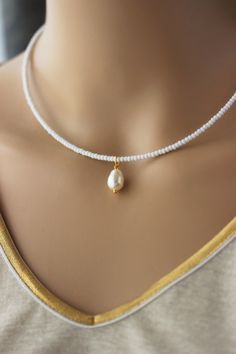 This dainty necklace was made of white glass and golsd tone seed beads, one high quality white pearl coated crystal drop bead, two layers of strong nylon thread, gold tone stainless steel end clasps with gold tone stainless steel lobster claw and gold tone stainless steel chain. Perfect minimalistic summer jewelry! You can wearing it with other necklaces or alone! The length of necklace is about 41 cm or about 16.1 inches and 4 cm of adjustable length gold tone chain. Other necklaces you can fin One Pearl Necklace, Pearl Drop Pendant, White Choker, Beads Choker, Drop Beads, Glass Seed Beads, Crystal Drop, Beaded Choker, Drop Pendant