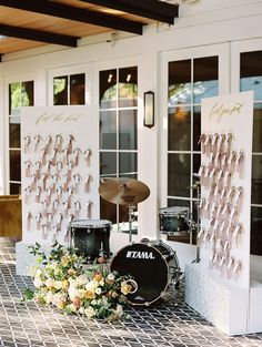 a drum set up next to some flowers